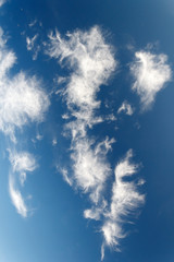 blue sky with white clouds and sun