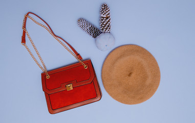 Stylish red clutch and beret. Fall season flat lay art