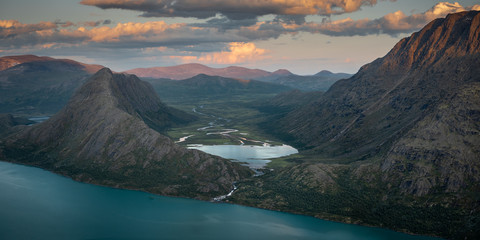 Sunset light over mountains and valleys in the Jotunheimen national park - obrazy, fototapety, plakaty