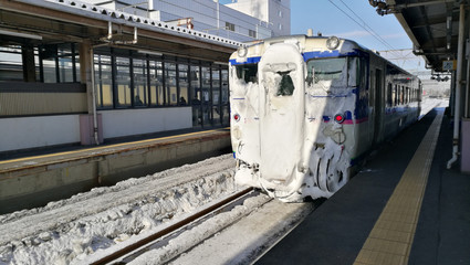 Train covered by a lot of snow in winter at Japan. Transportation delay because of bad weather.
