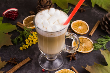 coffee latte with marshmallow on autumn background, maple leaves, oranges, cinnamon