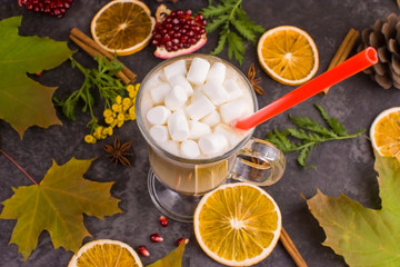 coffee latte with marshmallow on autumn background, maple leaves, oranges, cinnamon