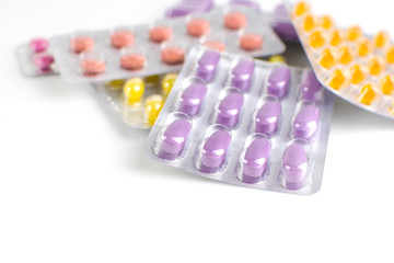 Various pills, drugs on a light background. Pharmaceutical product.