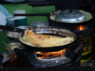Delicious vietnamese savory pancake fried on hot pan with stove