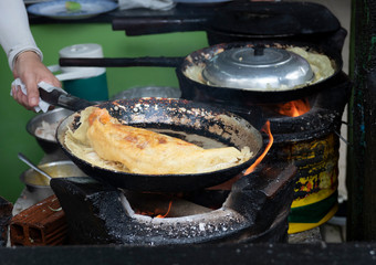 Delicious vietnamese savory pancake fried on hot pan with stove
