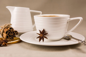 Masala tea is a traditional Indian drink in a Cup with spices on a light background