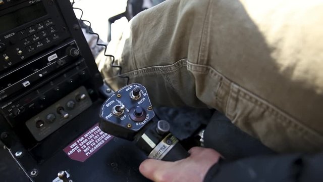 Man pushing button at helicopter throttle