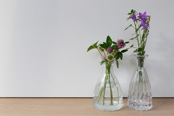 bouquet of flowers in a vase on wooden background