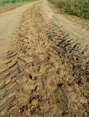 Tracks left by a tractor, on wet soil, ready for cultivation