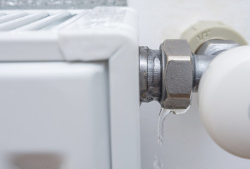 Leaking heating radiator valve. Defective heater. The need for plumbing work in the heating period...
