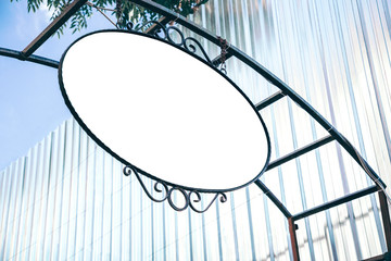 Mock up of round forged metal signboard template with copy space. Hanging blank vintage sign. Bottom view.