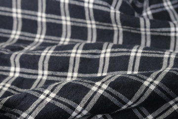 The background plaid fabric with wrinkles.