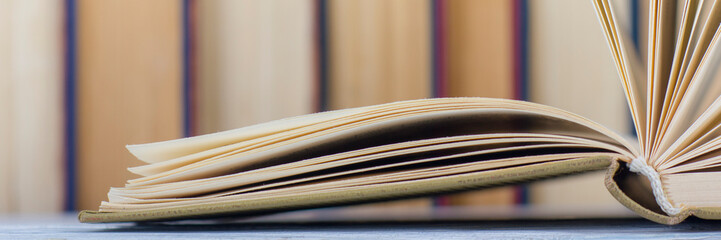 Open book, hardback books on wooden table. Back to school. Copy space