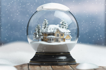 Merry christmas snow globe with a house on snowfall winter background.