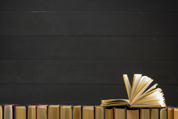 Open book, hardback books on wooden table. Back to school. Copy space