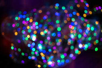 Beautiful Christmas background with garlands and bokeh. New year  multi-colored picture. Abstract photo image for design