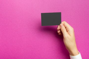 Hand holding business card blank on abstract background
