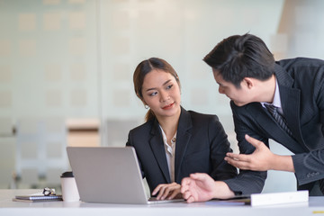 Young businessman communicating with woman at the table