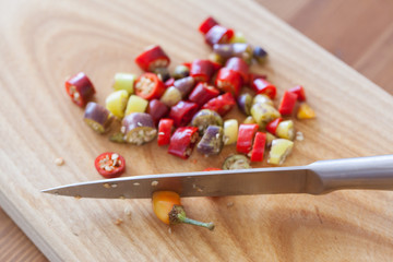 Knife cut hot chili pepper on the board