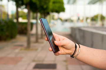 hand holding a purple cell phone with the black screen