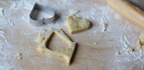 the dough for the shortbread in a heart shape on cutting Board