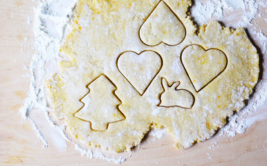the dough for the shortbread in a heart shape on cutting Board