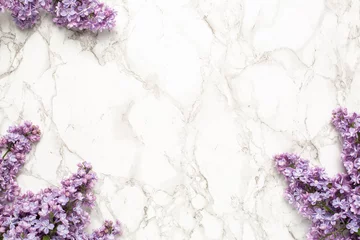 Möbelaufkleber Purple lilac flowers on marble background, simple composition for holiday © KatrinaEra