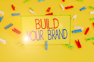 Word writing text Build Your Brand. Business photo showcasing enhancing brand equity using advertising campaigns Colored clothespin papers empty reminder yellow floor background office