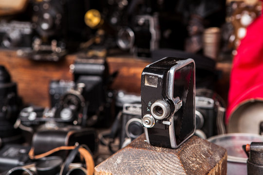 Vintage soviet movie camera on flea market with other cameras at the background.