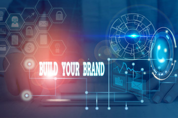 Fototapeta premium Writing note showing Build Your Brand. Business concept for enhancing brand equity using advertising campaigns Picture photo network scheme with modern smart device