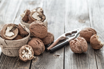 Organic Walnut lies on a wooden background , close-up .