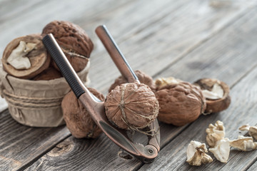Organic Walnut lies on a wooden background , close-up .