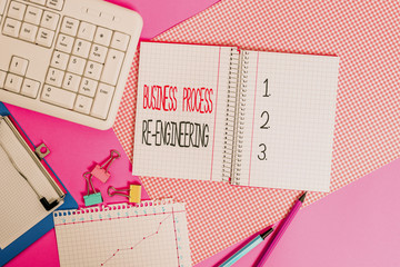 Word writing text Business Process Re Engineering. Business photo showcasing the analysis and design of workflows Writing equipments and computer stuffs placed above colored plain table