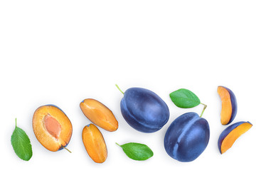 fresh blue plum and half with leaves isolated on white background. Top view. Flat lay