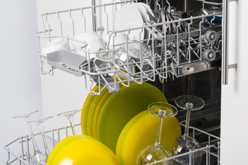 dry clean dishes in the basket of an open dishwasher
