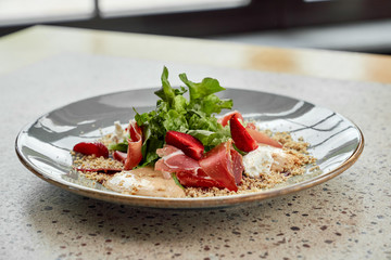 Salad with jamon and strawberry.