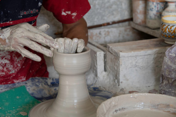 Close-up motion of hands making large ceramic vase
