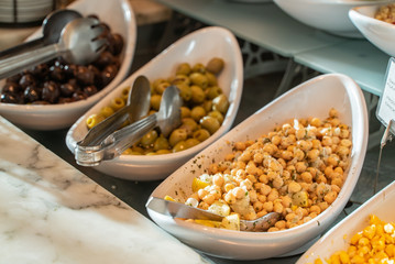 table with different kinds of salads and snacks