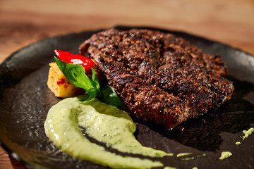 Tasty steak with spinach sauce.