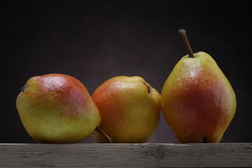 Three pears on old table