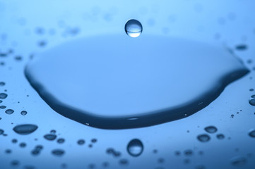 water splashes on glass on a blue background drops of water
