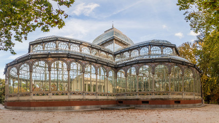 Fototapeta na wymiar Palacio de Cristal (Glass Palace) in Retiro park in Madrid, Spain