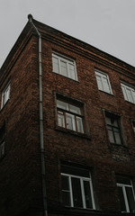 Fototapeta na wymiar An old residential building against the gray sky. Architecture of Soviet Union times.