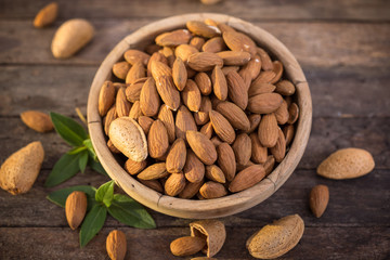 Fresh almonds in the wooden bowl