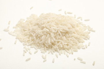 handful of white rice on a white table