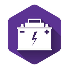 White Car battery icon isolated with long shadow. Accumulator battery energy power and electricity accumulator battery. Lightning bolt symbol. Purple hexagon button. Vector Illustration