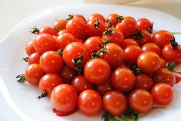 small red tomatoes in a plate