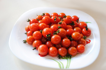 small red tomatoes in a plate