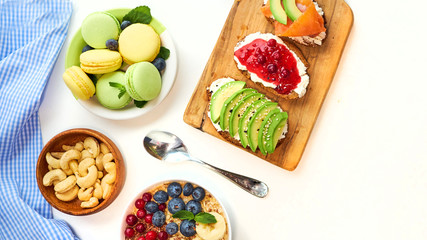 breakfast top view isolate white background. oatmeal with berries, toasts on a wooden tray, nuts, coffee