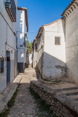 Fototapeta na wymiar Narrow street in Albaycin neighborhood of Granada, Spain